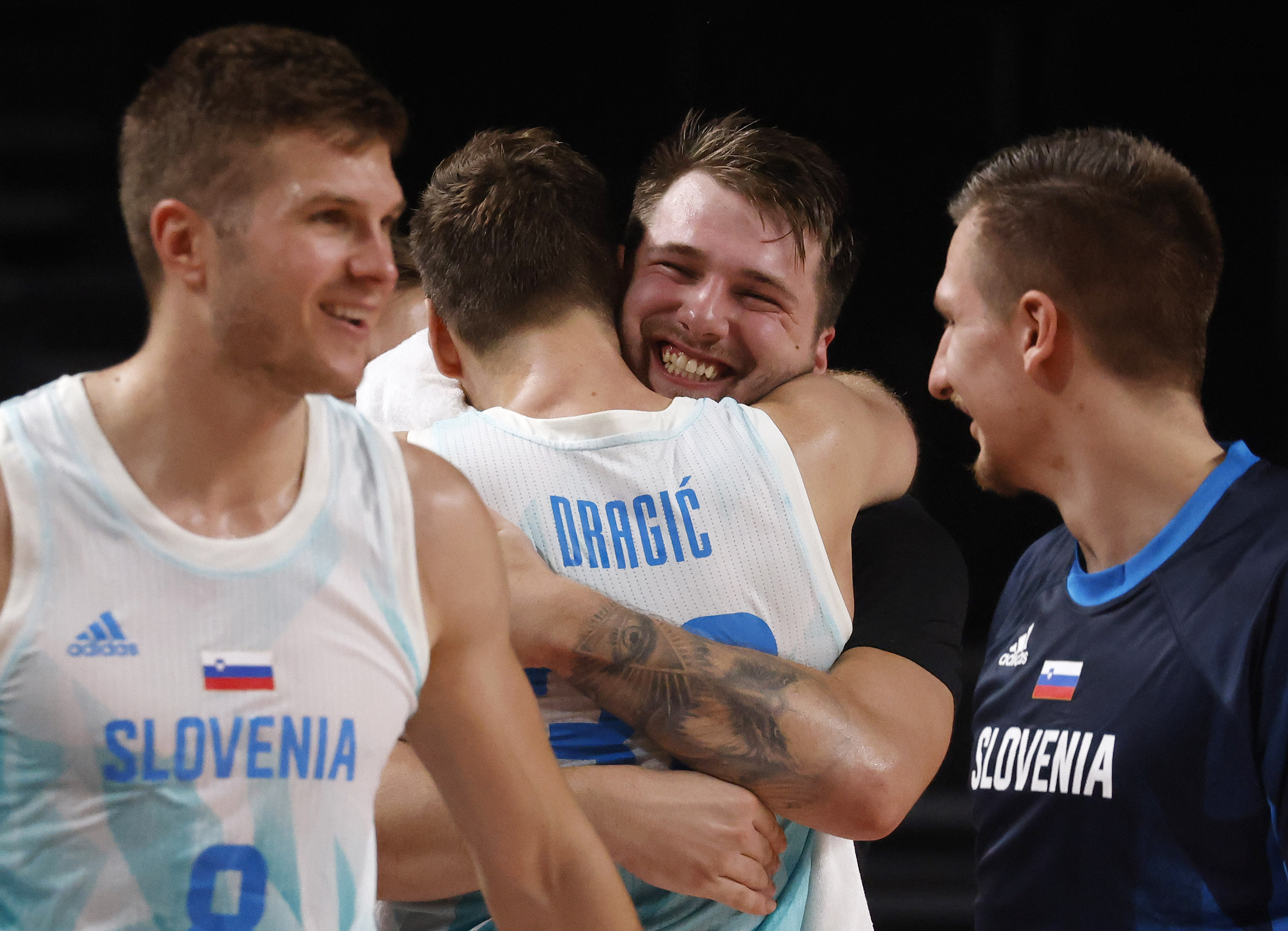 Slovenia’s Luka Doncic (77) hugs Zoran Dragic (30) after both were pulled from play late in the game against Germany during the second half of play of a quarter final basketball game at the postponed 2020 Tokyo Olympics at Olympic Stadium, on Tuesday, August 3, 2021, in Tokyo, Japan. Slovenia defeated Germany’s 94-70. (Vernon Bryant/The Dallas Morning News)